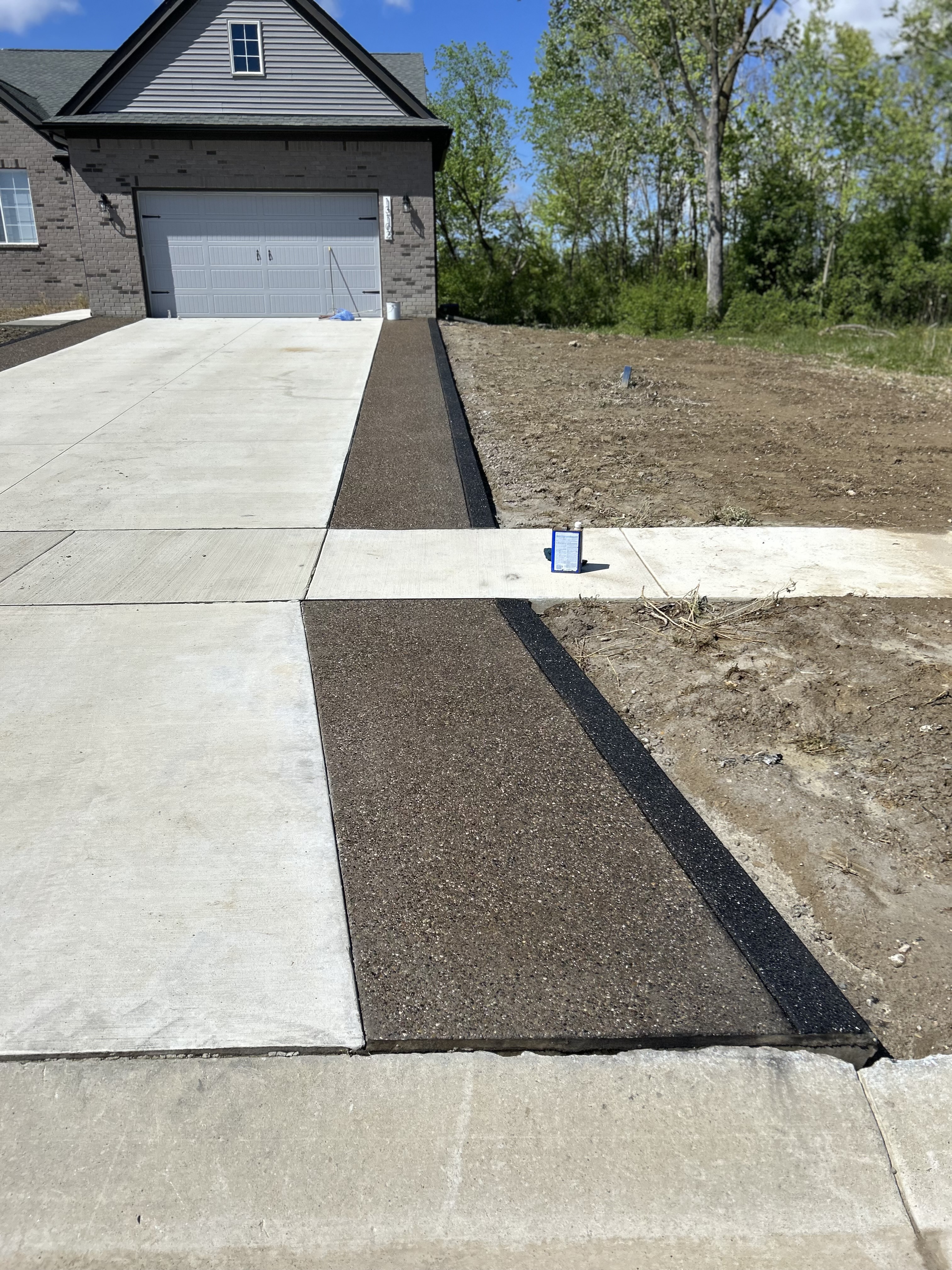 Exposed aggregate concrete by Mitten Made Concrete