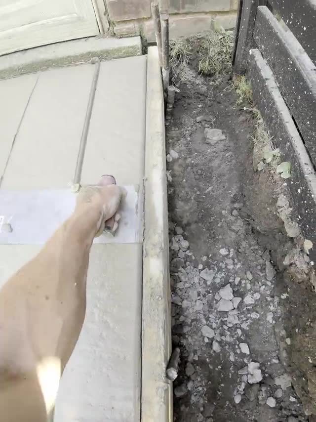 Hand tooling a decorative edge on a custom patio in Berkley MI