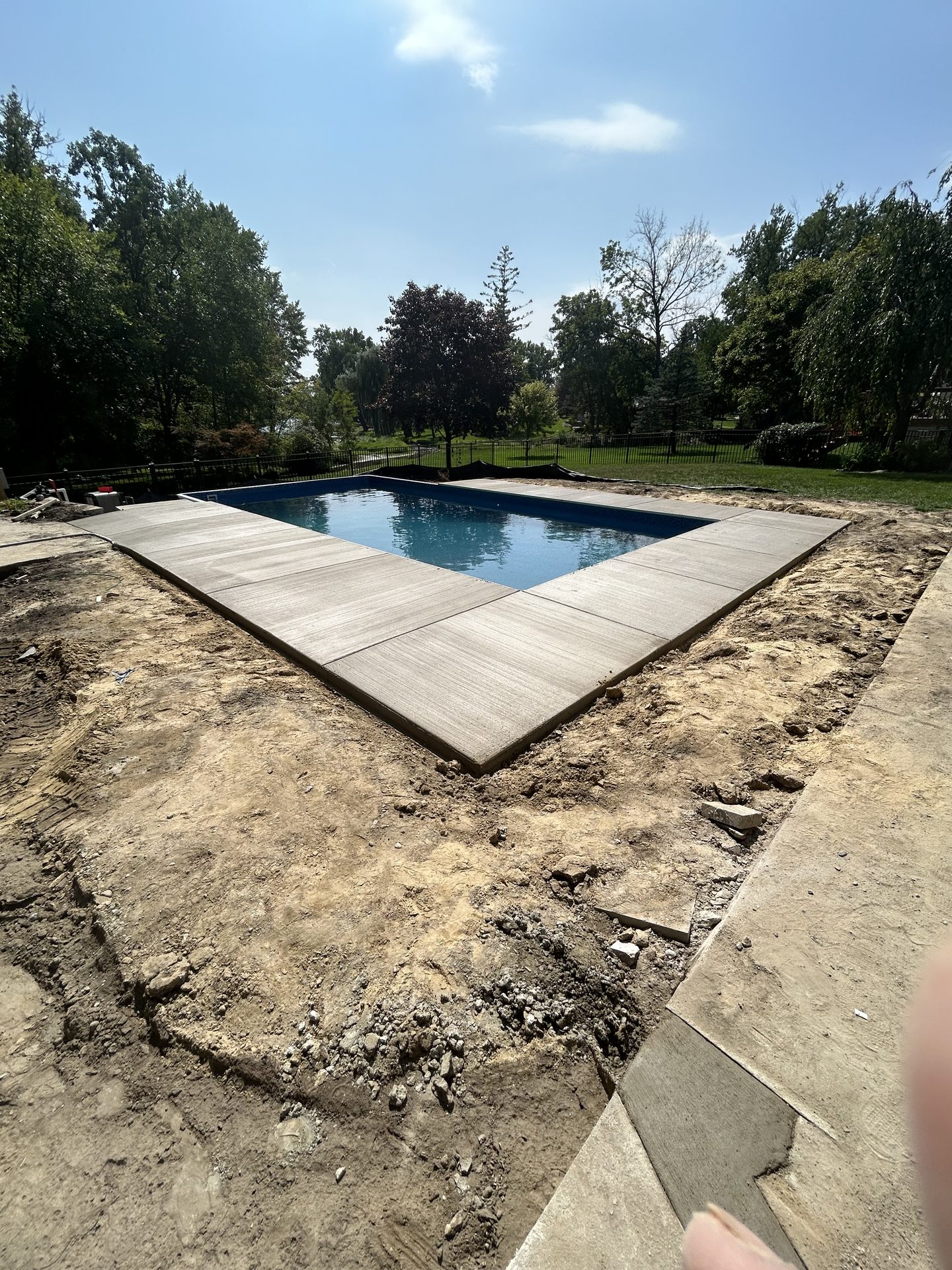 Concrete pool deck poured around an inground pool in Metro Detroit